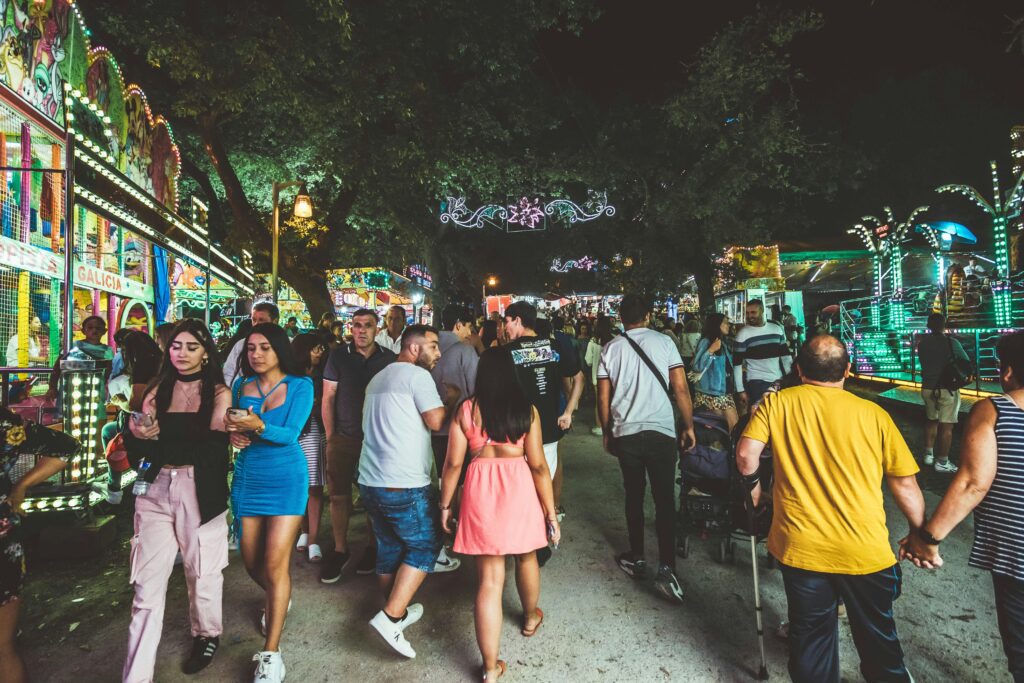 People enjoying a vibrant festival night in Santiago de Compostela, Spain.